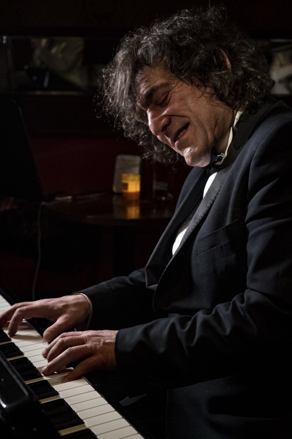 Robin Finesilver looking up while playing piano